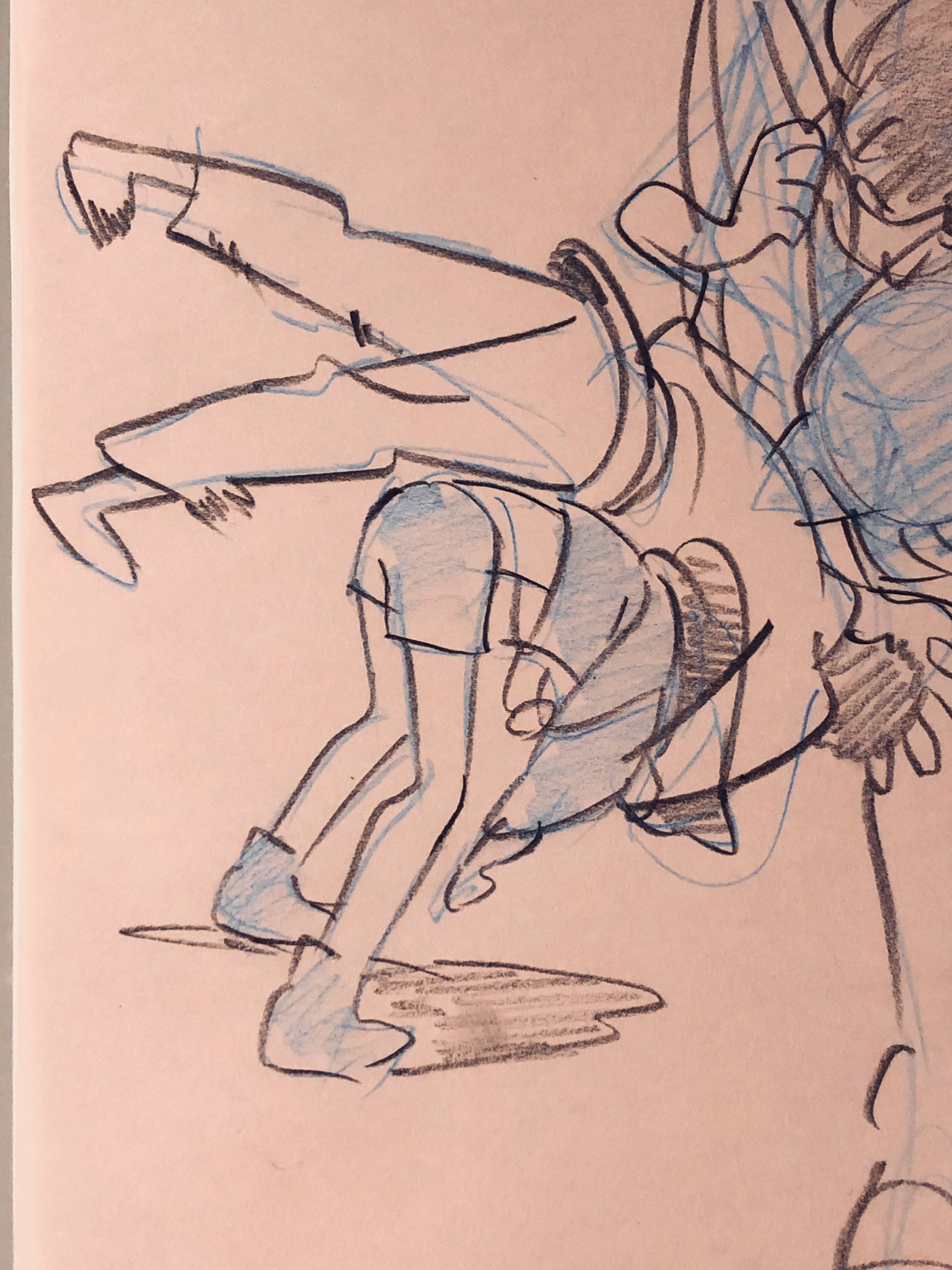 a sketch of two figures in motion. one figure is being lifted or carried by the other, their limbs are intertwined suggesting a playful struggle or dance. the figures appear to be wearing casual clothing and are set against a plain background. the style of the drawing is loose and energetic, utilizing quick strokes and minimal detail.