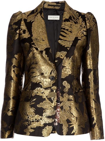 a black and gold patterned blazer with a lapel, a button closure, pockets, a lining, and puffed shoulders.