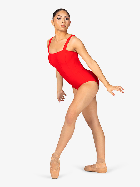 a fullbody studio shot of a female ballet dancer wearing a red square neck leotard and pointe shoes. she's posed midstep, slightly angled away from the camera, highlighting her elegant posture and graceful form.  the background is pure white, allowing the vibrant red leotard and the dancer's pose to stand out.