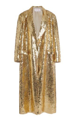 a gold valentino sequined coat. the coat is floorlength and has a collar.
