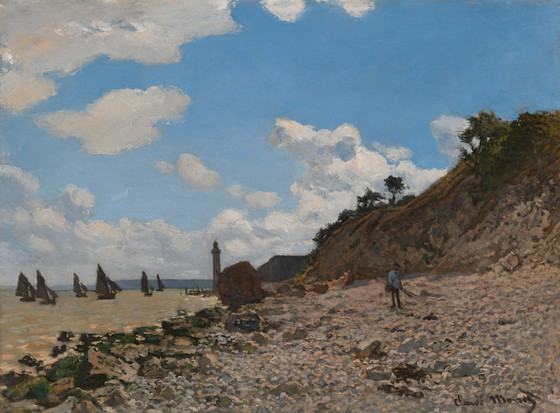 a painting by claude monet depicting a beach with sailboats in the distance. a lighthouse stands near a rocky area on the beach. a cliff rises on the right side of the image with trees and vegetation on top. a man is walking on the pebble beach. the sky is blue with white clouds.