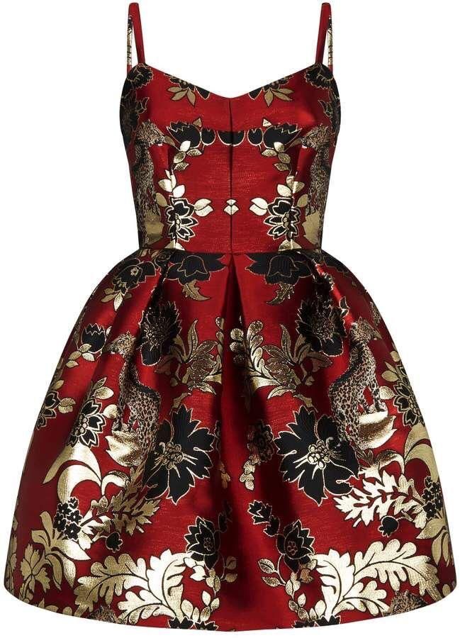 a red fitandflare dress with a gold and black floral pattern. the dress has spaghetti straps and a sweetheart neckline. the fabric appears to be textured. the dress is sleeveless and short.