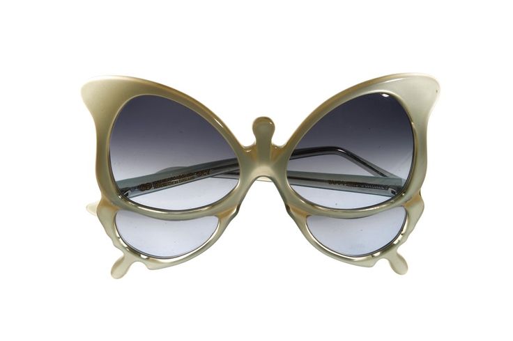 a pair of butterflyshaped sunglasses with gradient lenses is centered on a white background. the frames are a light, neutral color and feature a distinct butterfly wing design.