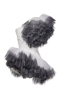 a closeup of a white and grey tulle skirt with ruffles. the skirt is layered and delicate, with a soft, feminine feel. it would be perfect for a special occasion, such as a wedding or prom. the skirt is airy and elegant, and the tulle is sheer and light. the skirt is a beautiful example of fashion and design.