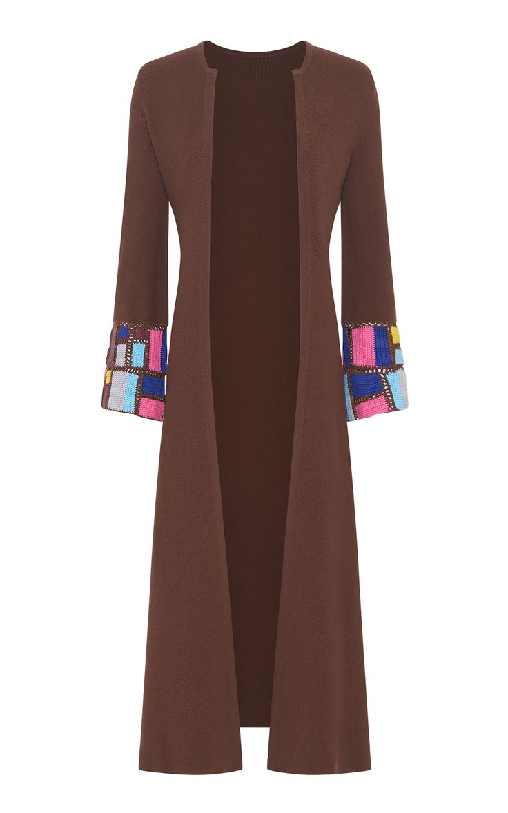 a brown longsleeved cardigan with a colorful crochet trim on the cuffs. the cardigan is open in the front and has a relaxed fit. it is made of a soft knitted fabric.  it is a stylish and versatile piece that can be dressed up or down.