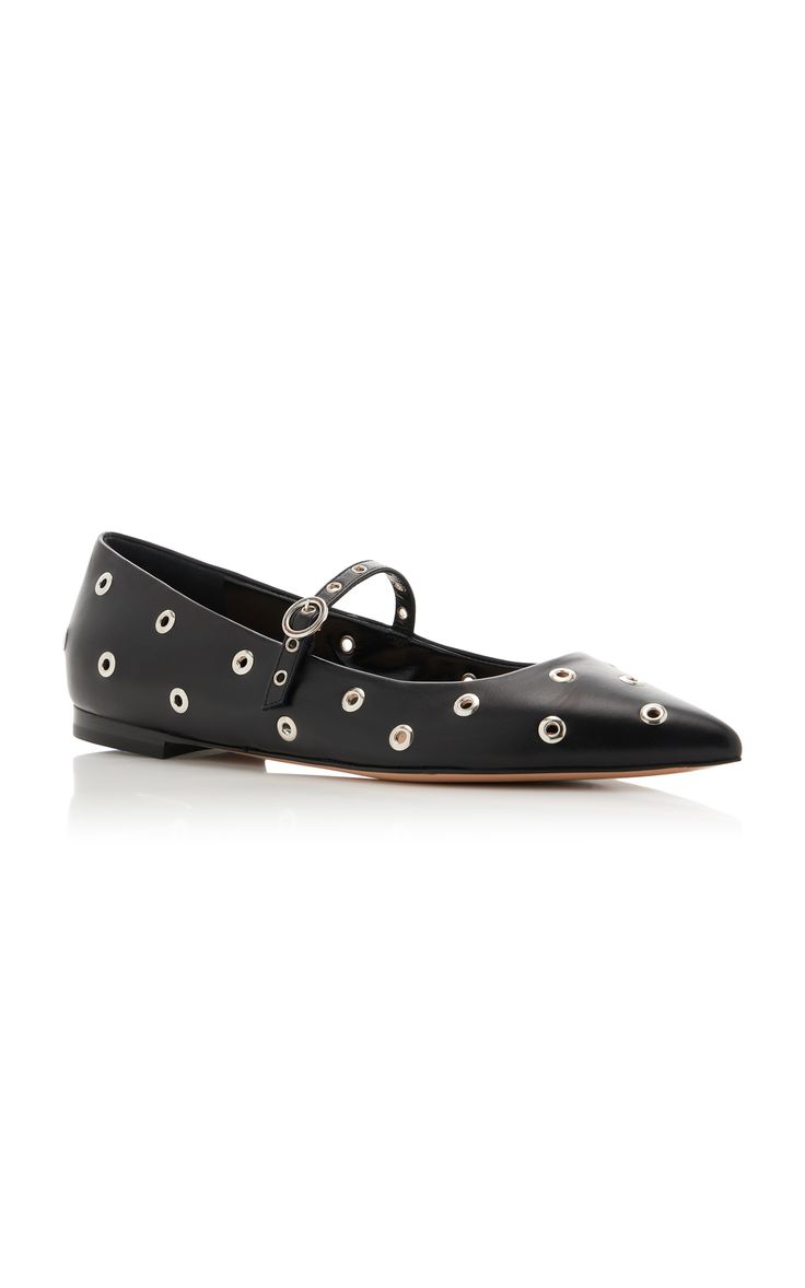a pair of black leather pointedtoe flats with eyelets and a thin mary jane strap.  the shoes are shown on a white background.  they appear to be stylish and possibly designer.