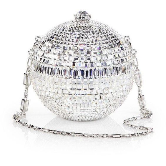 a silver disco ball clutch purse with a chain strap. the clutch is made of a mirrorlike material covered in crystals and rhinestones. the chain strap is made of silver metal. the purse is a glamorous and stylish accessory that would be perfect for a night out.