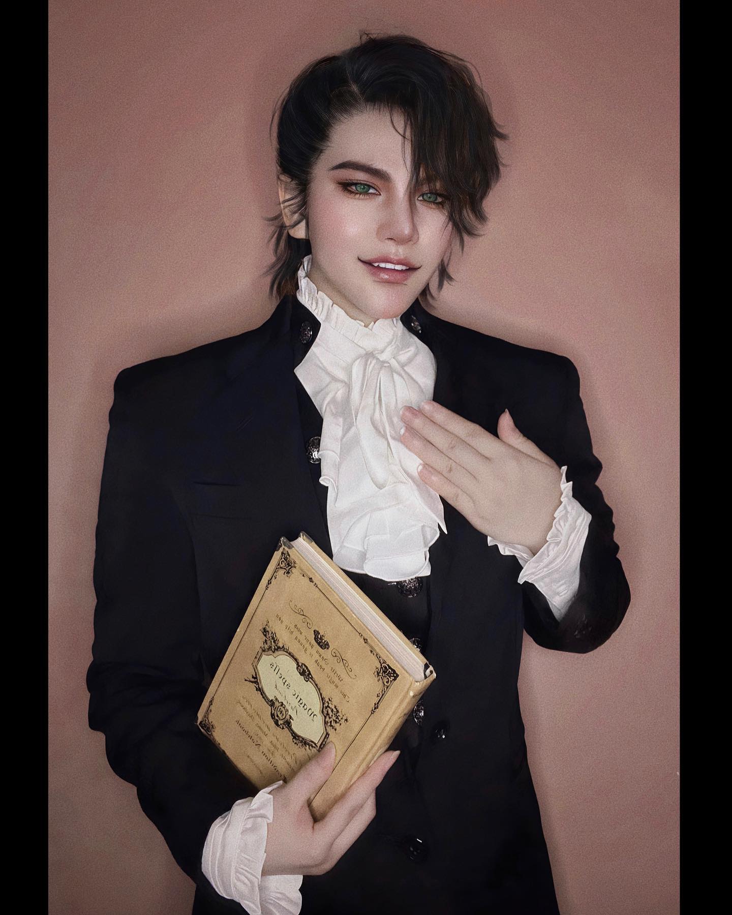 a young man with long black hair is wearing a black suit jacket and white shirt with a black bow tie. he is holding a book in his left hand and his right hand is on his chest. he is looking at the camera with a slight smile. the background is a light pink wall.
