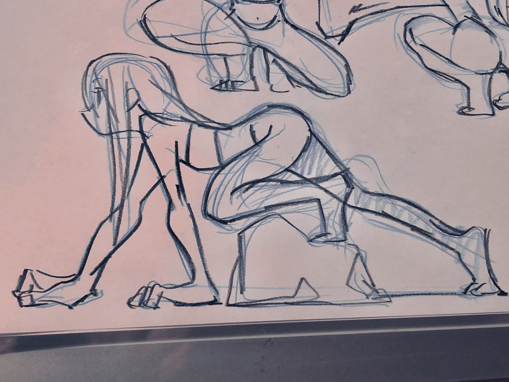 the image is a sketch of a woman in a dynamic pose, seemingly about to crawl.  the drawing focuses on capturing the human form and movement. there are other sketches of figures in the background, indicating a practice session for figure drawing. the use of lines suggests a quick and expressive style.