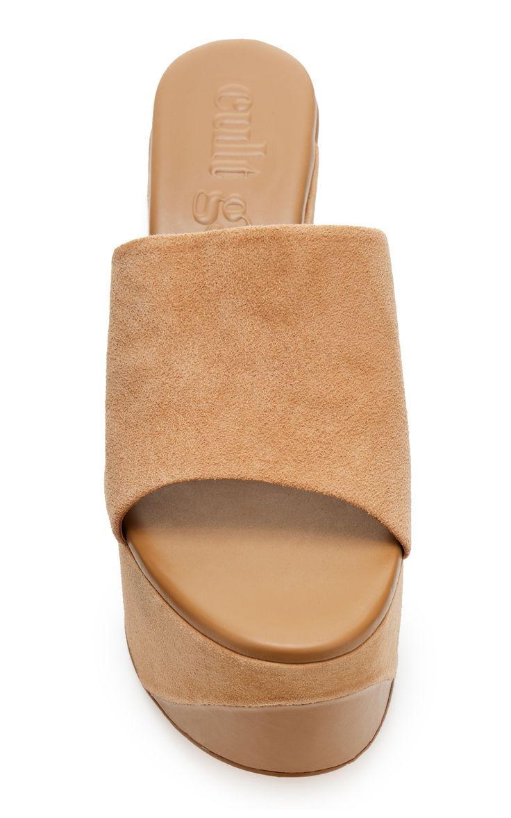 a closeup studio shot against a white background shows a pair of women's camilla skovgaard tan suede platform sandals.  the sandals have a thick platform sole and a simple, opentoe design. the brand name is visible on the insole. the shoes appear to be made of highquality suede.