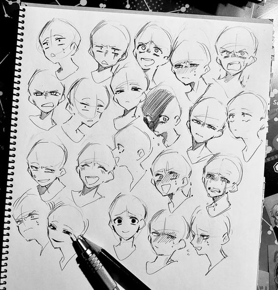 the image is a sketchbook page filled with pencil sketches of various facial expressions.  there are at least twenty different faces, all drawn in a stylized, manga or anime style. the expressions range from happy and excited to sad and angry, with a variety of emotions in between. the artist has used a variety of line weights and shading techniques to create a sense of depth and dimension in the drawings.