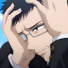 the image shows a closeup illustration of a young man with short dark hair. his face is partially obscured by his hands as he clutches his head in distress. he wears glasses and a dark uniform with a high collar. his expression conveys a sense of deep sadness, despair, and possibly anxiety. the soft lighting and limited background emphasize the emotional intensity of the moment.