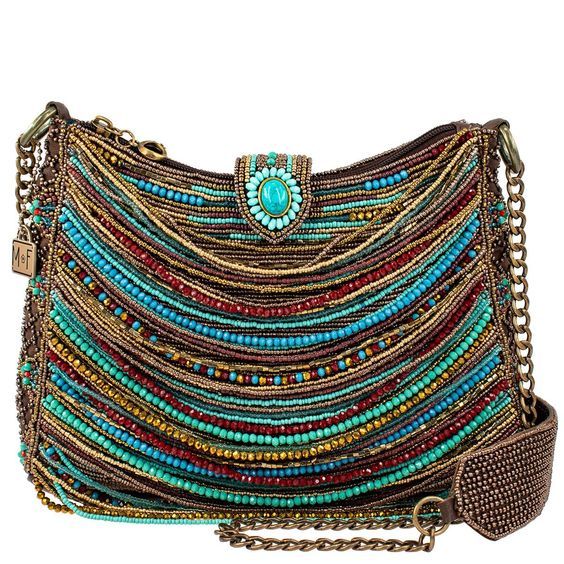 a colorful beaded handbag with a turquoise stone detail on the flap closure and a chain strap. the bag features various colors of beads including red, blue, brown, and gold.
