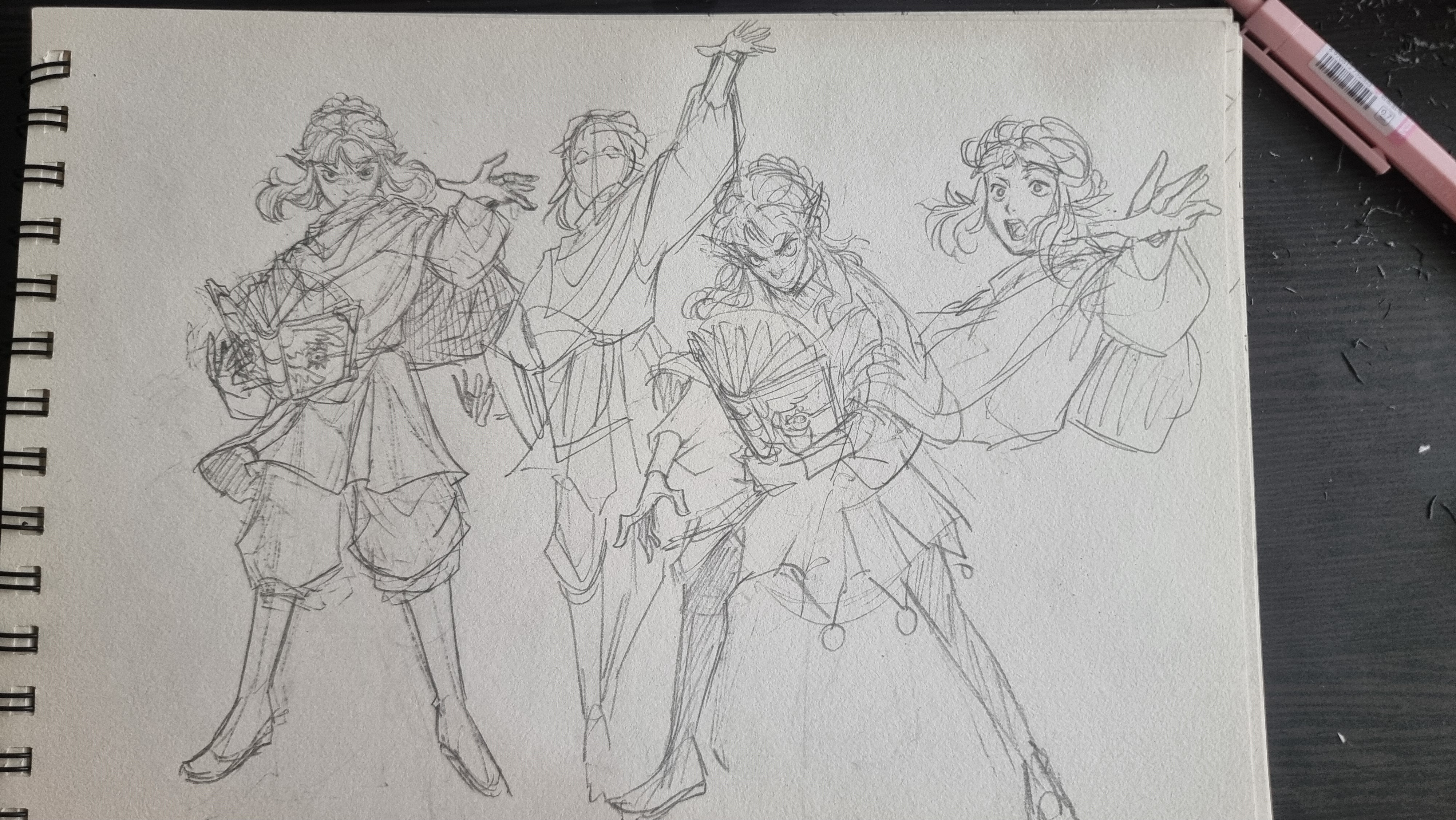 the image is a pencil sketch of a female character in four different poses. the character has long hair and is wearing a long flowing outfit. she appears to be holding a magical book in three of the poses. the sketch is drawn on a piece of paper from a sketchbook.  the top right corner of the image shows a mechanical pencil.
