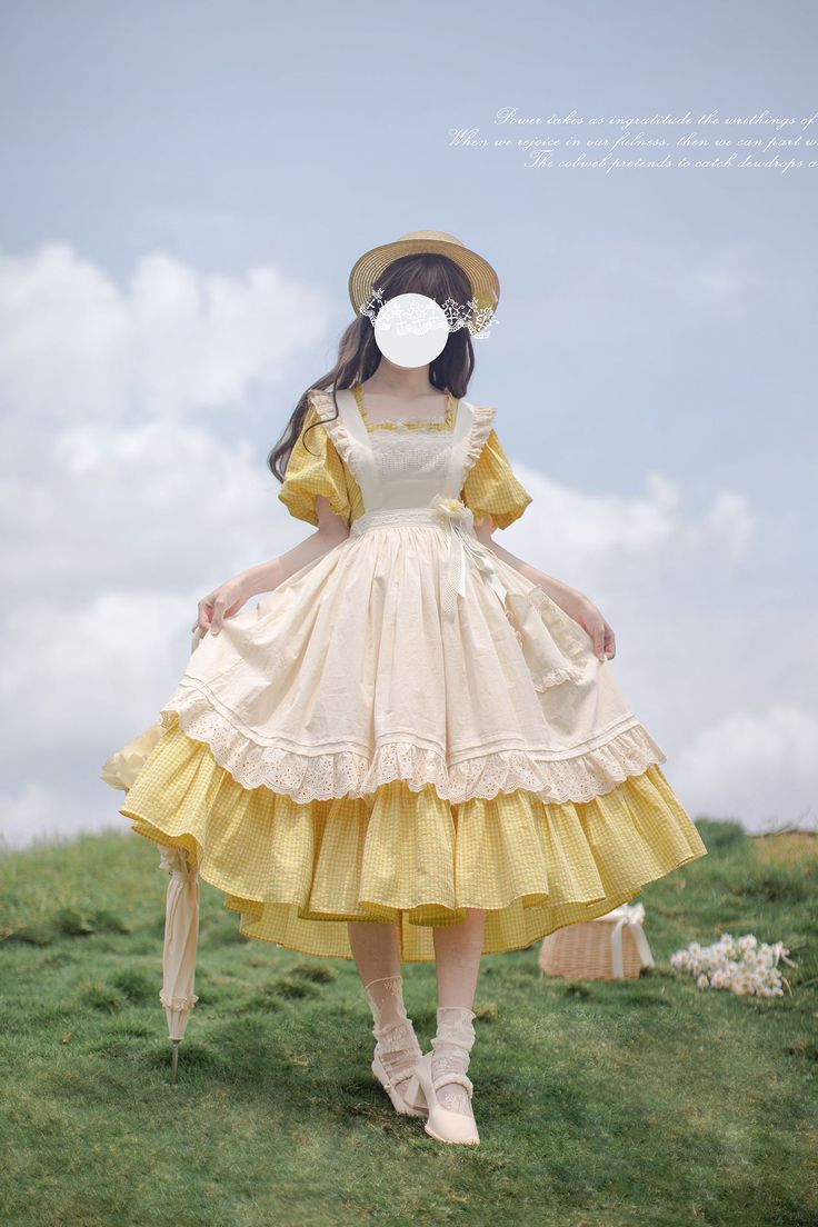 a woman in a yellow and white lolita dress stands in a field. she is wearing a straw hat and holding a white parasol. there is a basket of flowers next to her. the background is a blue sky with white clouds.
