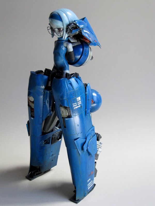 a blue animestyle robot toy stands on a light gray background, with its robotic legs and body built in detail and its right arm replaced with a blue, humanoidshaped figure. the robot looks like it's from a scifi anime. the robot is standing on a light gray surface, with its right leg slightly forward. the robot's legs are long and slender, and its body is built for movement and agility. the robot's head is small and round, with a blue helmet and a blue and white face that gives it a friendly and approachable appearance. the robot is a toy or model and is not actually a real robot. the toy is made of plastic and is wellmade, with a lot of detail. the robot's blue paint job is a nice touch. the robot is a cool and futuristic toy.