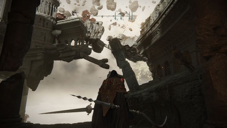 the image is a screenshot from the video game elden ring. it shows the player character, seen from behind, standing in a desolate, ruined environment. the architecture is gothic and dark fantasy style, with large, broken structures floating amidst debris in a gloomy sky. the player wields a large swordlike weapon. the overall atmosphere is mysterious and atmospheric, reflecting the game's setting.  the perspective looks up at the floating ruins.