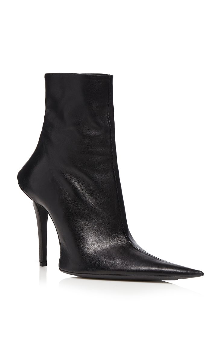 a pair of balenciaga black leather ankle boots with a pointed toe and stiletto heels. the boots are sleek and elegant, and would be a stylish addition to any wardrobe.  the image shows the boots on a white background, showcasing their design details.