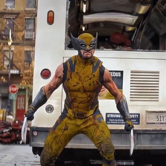 wolverine, the iconic xmen superhero, is in a fighting pose with his claws extended. he is standing in front of a white bus, the setting appears to be an urban street. wolverine is wearing his yellow and brown costume, his face is obscured by the mask and a fierce expression can be seen through the opening.  the image captures the intensity and action of the character, hinting at a thrilling scene from a comic book or movie.
