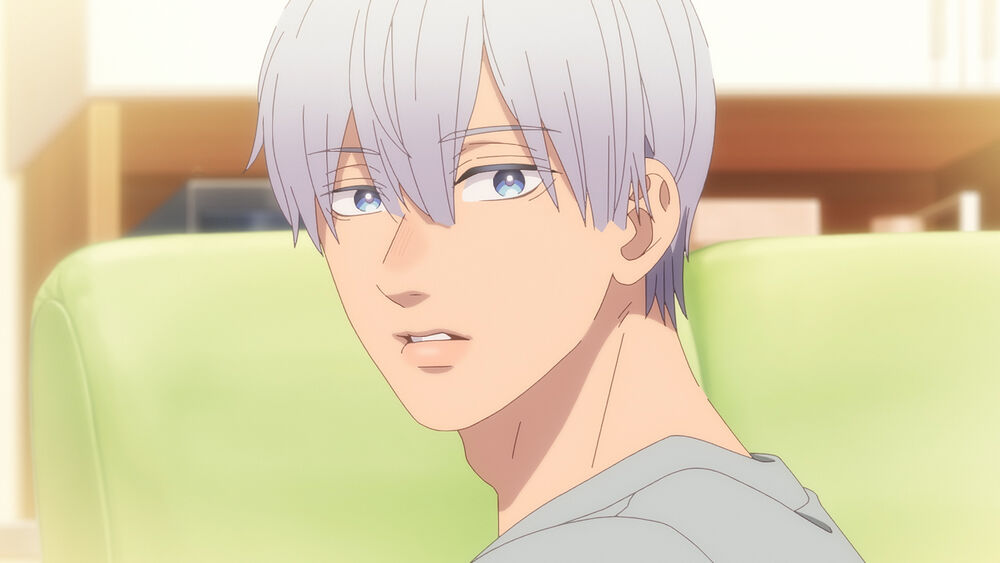 a closeup shot of an anime character with white hair and blue eyes. he appears to be indoors in a home setting and is looking off to the side with a thoughtful expression on his face. the lighting is soft and natural.