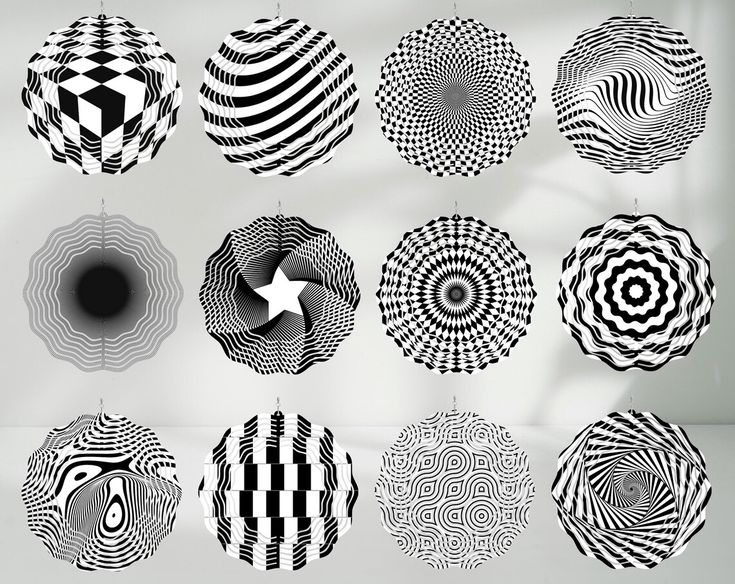 the image showcases a collection of twelve black and white patterned spheres suspended in front of a white wall. each sphere features a different optical illusion design, creating a visually dynamic and intriguing display of geometric patterns and op art.