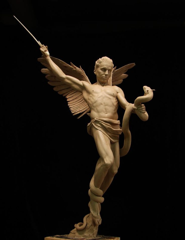 a clay sculpture of a winged angel standing on a pedestal. the angel holds a sword aloft in its right hand and grasps a serpent in its left hand. the serpent is coiled around the angel's body. the background is black.