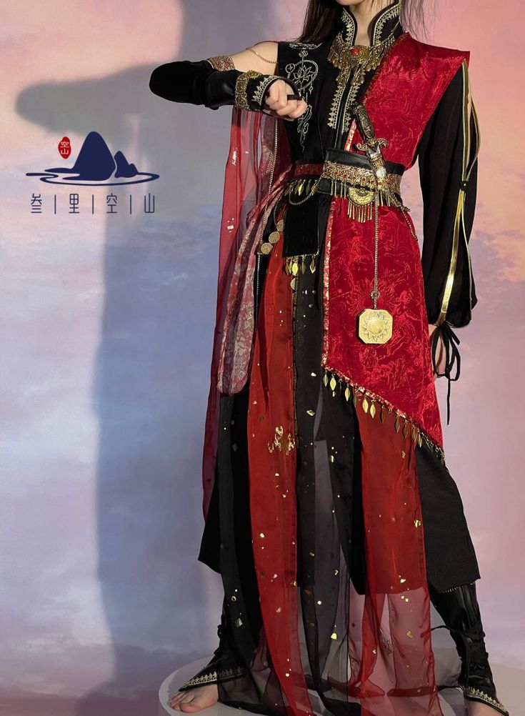 a woman in a traditional chinese style costume with red, black, and gold accents poses for a photo. the woman is wearing a black top with gold embroidery and a long red skirt. the costume is accented with a gold belt and numerous other gold accessories. she is also wearing a long red scarf around her neck. the woman is standing in front of a plain background and is looking directly at the camera.