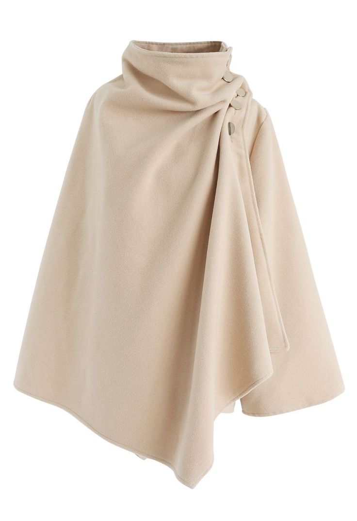 a beige cape with a turtleneck collar and button detail. the cape is made of a soft, comfortable fabric and is perfect for fall or winter. it is a stylish and chic piece that can be dressed up or down.