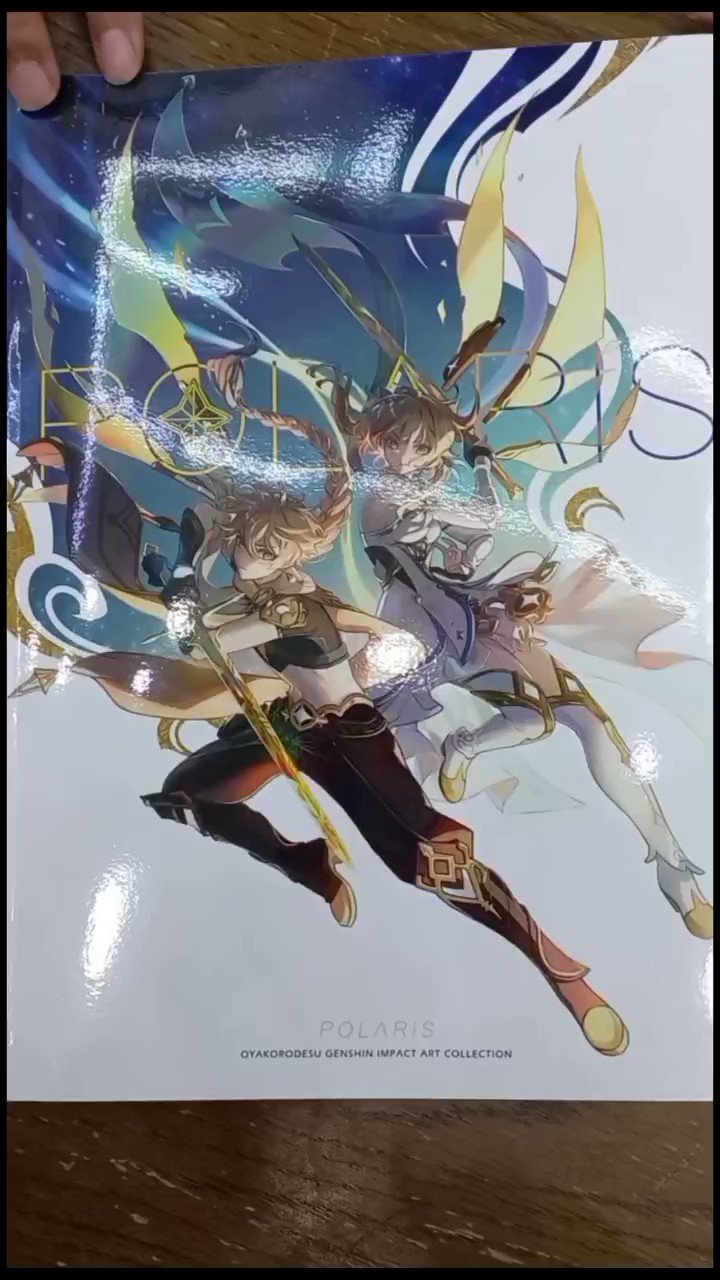 a closeup shot of an art book cover for "polaris: oyakorodesu genshin impact art collection". the cover showcases two anime characters, likely from the genshin impact game, posed dramatically.  the character in the foreground is a female character with reddishbrown hair, holding a swordlike weapon, and wearing a brown and black outfit. the character in the background is a female character with blond hair, wearing a light blue and white outfit.  the background of the cover features a beautiful design with swirling blue lines and hues.  the title "polaris" and the tagline "oyakorodesu genshin impact art collection" are prominently featured on the cover.