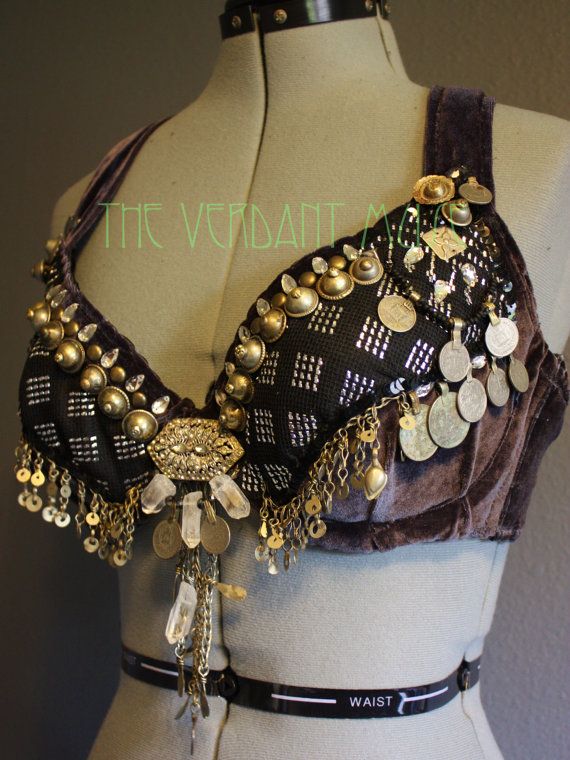 a handmade belly dancing bra made from a combination of velvet, black fabric, and embellishments, featuring coins, crystals, and sequins.