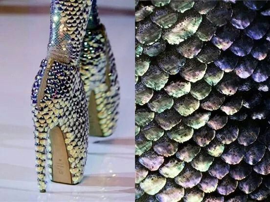 a pair of high heels, with a stiletto heel and platform, made of iridescent scales that resemble those of a snake or mermaid. the shoes are sparkling and glamorous, with a fashionforward design.