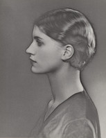 black and white profile portrait of a young woman from the 1920s or 1930s. she has a short bob hairstyle and is dressed in an elegant, simple dress. the photograph is taken in a classic style with soft shadows and a focus on her serene expression.