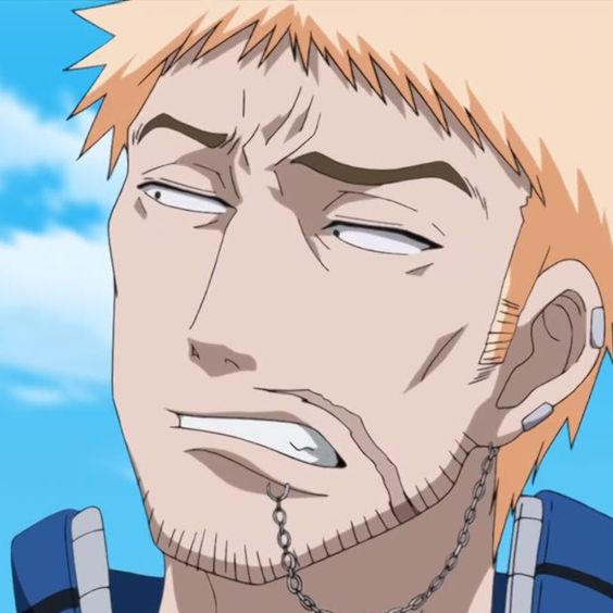 the image shows a closeup illustration of a male anime character with short blond hair and a goatee. he has a skeptical and annoyed expression on his face, with narrowed eyes, a furrowed brow, and his mouth slightly open in a grimace. he has a small chain earring dangling from his right ear.  the background is a bright blue sky.