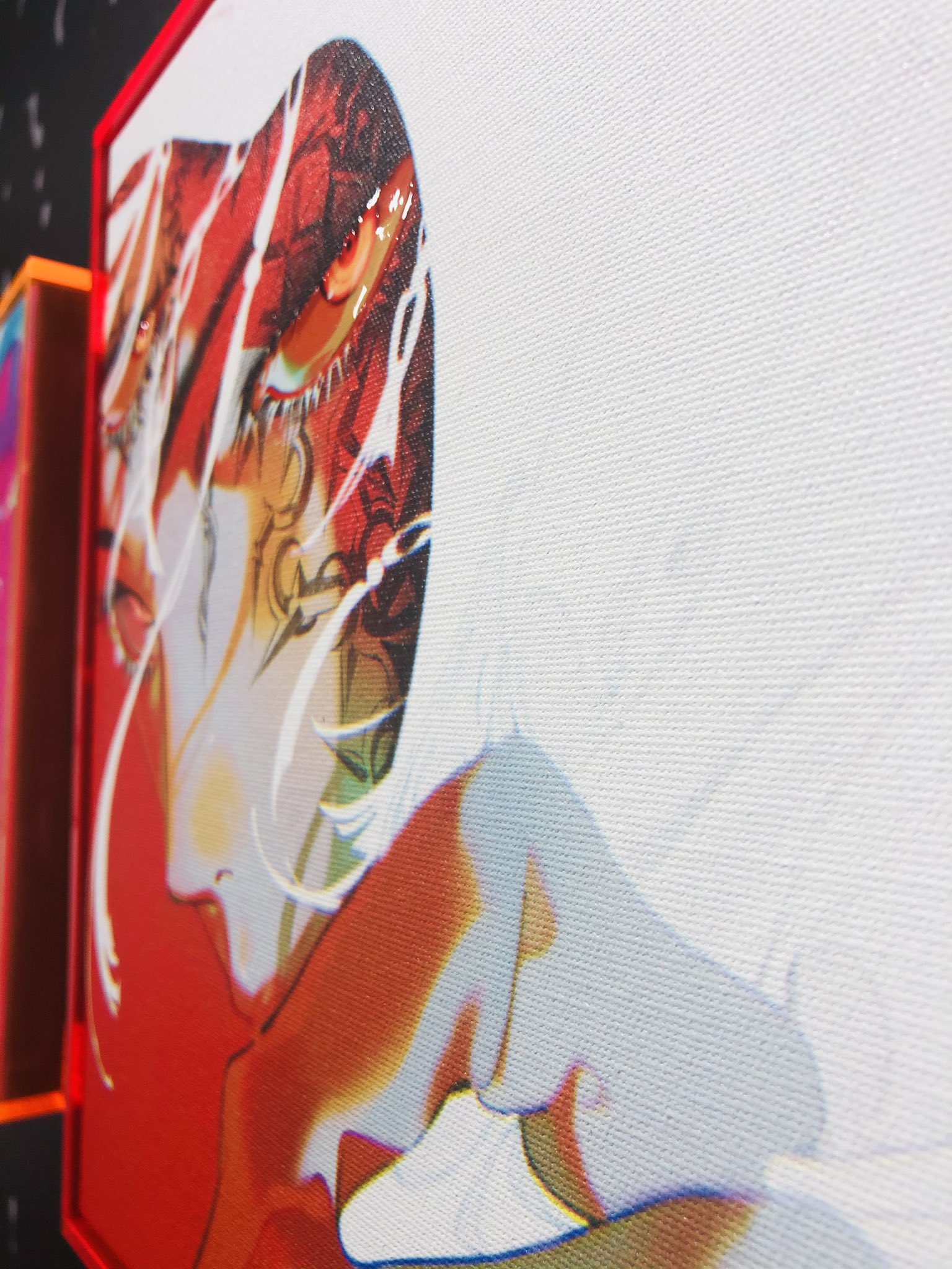 this image showcases a captivating closeup of a contemporary portrait painting. the artwork features a woman's face in profile, partially obscured by bold strokes of red and white paint. her intense gaze, directed away from the viewer, draws the eye, while the interplay of light and shadow creates a sense of depth and intrigue. the painting's vibrant color palette and expressive brushstrokes contribute to its overall impact, leaving a lasting impression on the observer. the setting suggests a gallery or exhibition space, further emphasizing the artistic context of the piece.