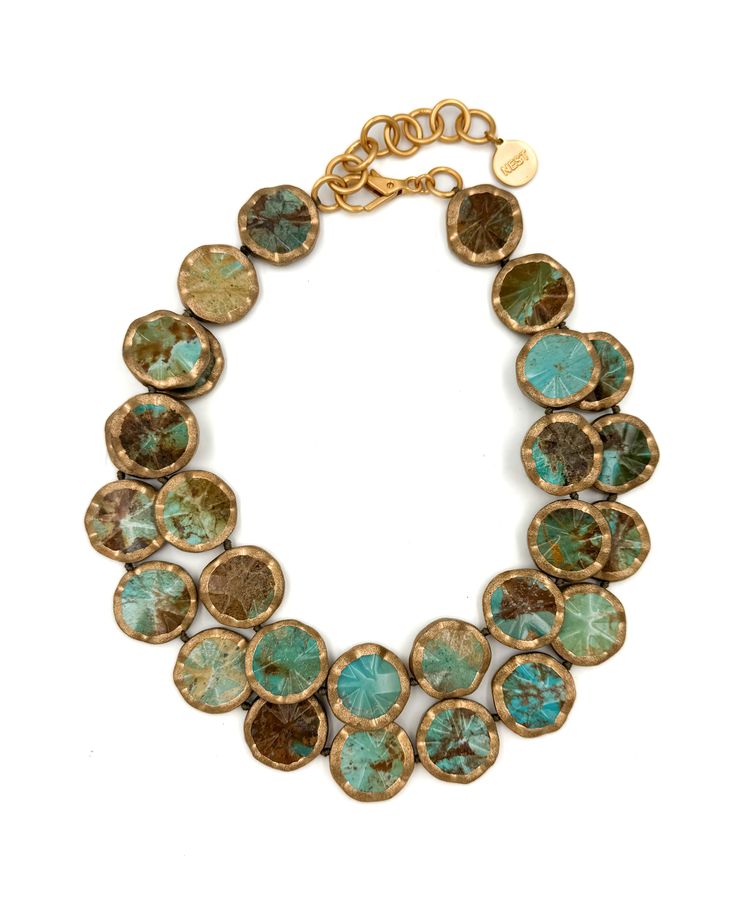 a close up of a beautiful, handmade turquoise and gold necklace. the necklace is made up of multiple strands of large, round, turquoise beads, each with a gold rim. the necklace is displayed on a white background.