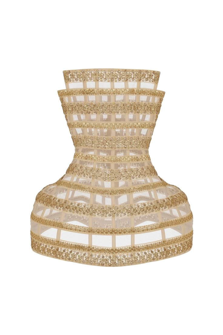 a sleeveless, waistlength dress form or mannequin decorated with a lattice pattern of gold beads.