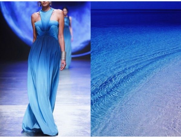 a fashion model walks the runway wearing a long, blue ombre gown. the background is a blur of blue, suggestive of the ocean. on the right is a close up of the ocean and beach.
