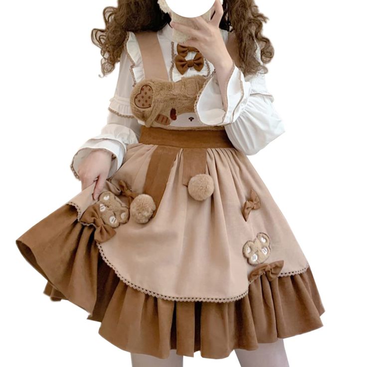 a woman is modeling a brown lolita dress. the dress has a bear theme and features a brown and cream color scheme. the dress has a tiered skirt and a cute bearshaped pocket on the bodice. the woman is also wearing a white blouse with a peter pan collar and a brown bow tie.