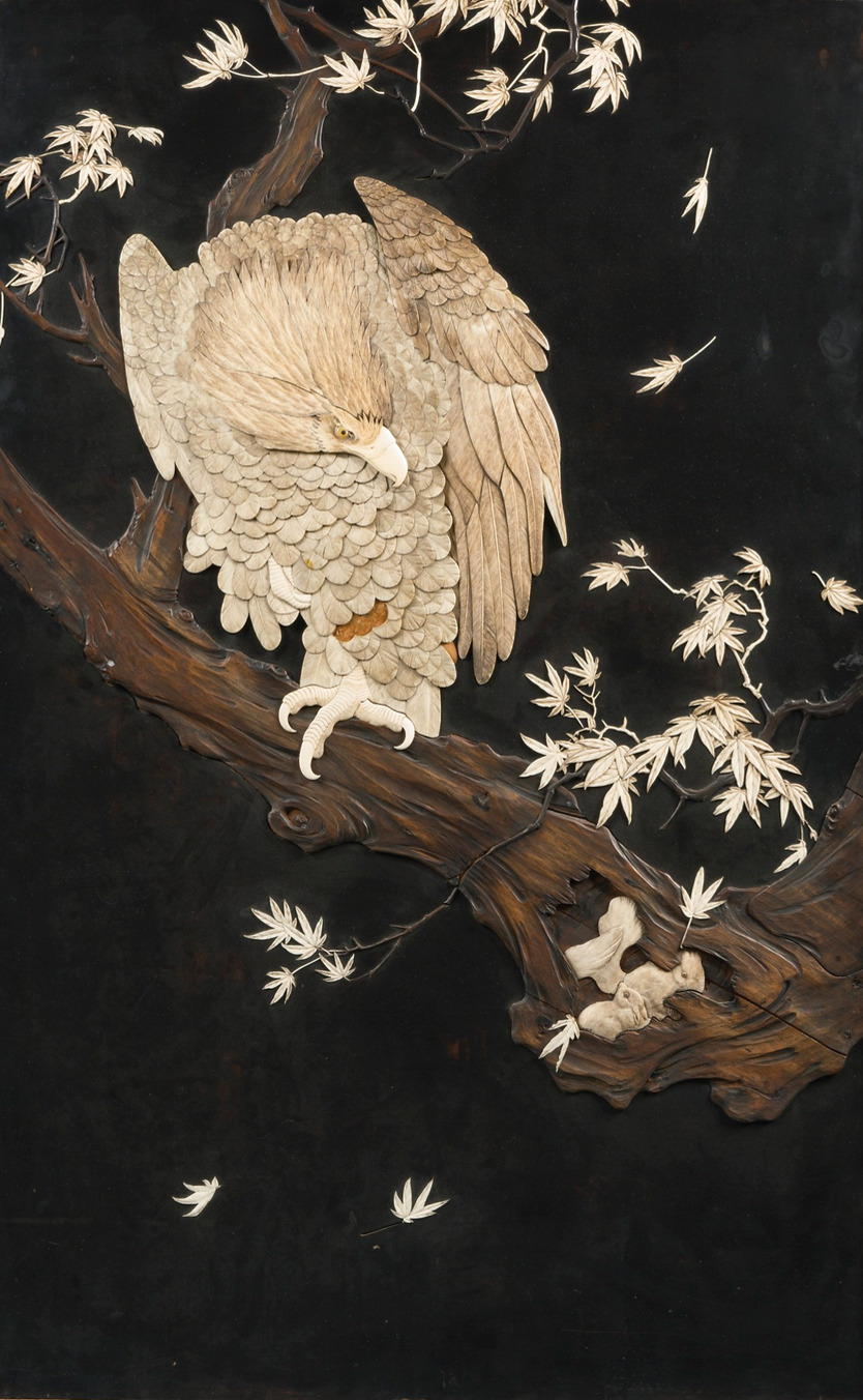 the image showcases a meticulously crafted wood carving of an eagle perched on a branch. the eagle, rendered with remarkable detail, dominates the composition, its feathers individually carved and layered to create a sense of depth and texture. the branch, gnarled and lifelike, extends diagonally across the artwork, providing a perch for the bird. delicate leaves, scattered across the composition, add a touch of elegance and movement. the dark background accentuates the intricate details of the carving, highlighting the artist's skill and craftsmanship.