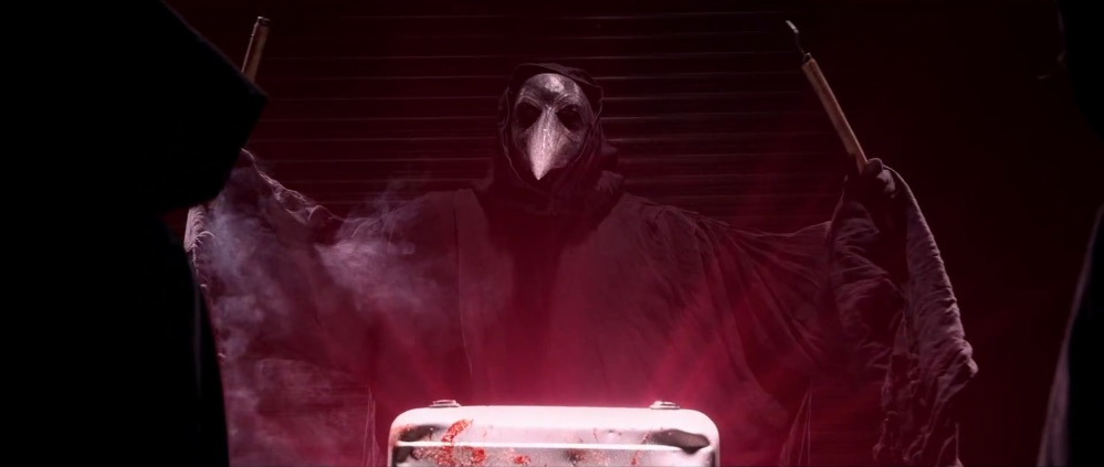 a hooded figure with a plague doctor mask stands in a darkened room. the figure is shrouded in darkness, but is illuminated by a red light.  the figure's long black robe billows in the wind and is obscured by smoke. it appears to be holding a long, thin object in its hands.  the figure's expression is obscured by the mask, but it looks menacing.