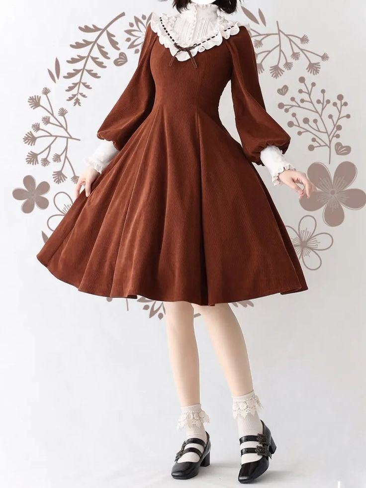 a woman is wearing a brown corduroy dress with a white lace peter pan collar. the dress has long sleeves and a full skirt. she is also wearing white socks and black mary jane shoes.  the image appears to be taken in an indoor setting with studio lighting.