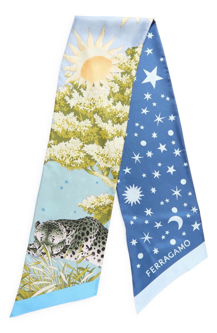 a blue, white, green, and yellow silk scarf with a print of a sun, moon, stars, leopard, and floral pattern. the scarf is folded in half and is laying flat. the word "ferragamo" is printed on the scarf in white letters. the scarf is a luxury fashion accessory.