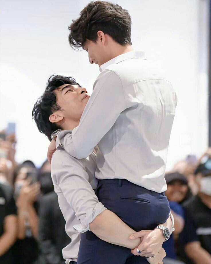 two men are hugging each other tightly
