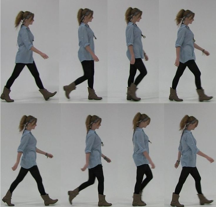 this image shows a woman walking in a studio with a white background. she is wearing a blue shirt, black pants, and brown boots. she is walking from left to right, and there are 8 different frames of her walk.