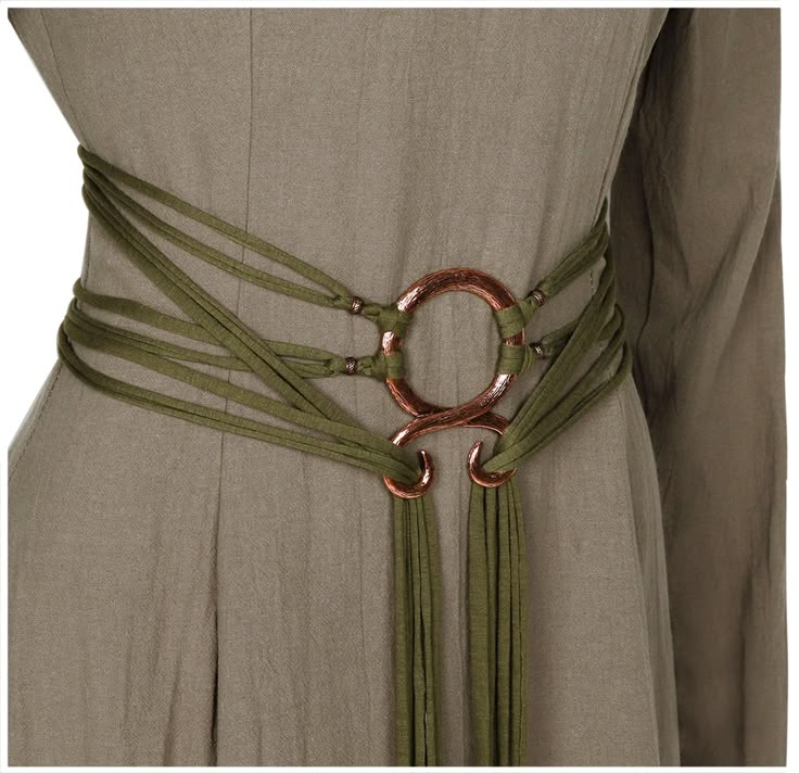closeup shot of a dress with an olive green fabric belt featuring a copper ring design at the center of the waist. the belt has multiple fabric strands wrapping around the waist, converging at the ring design, and then draping down in a tassellike fashion.