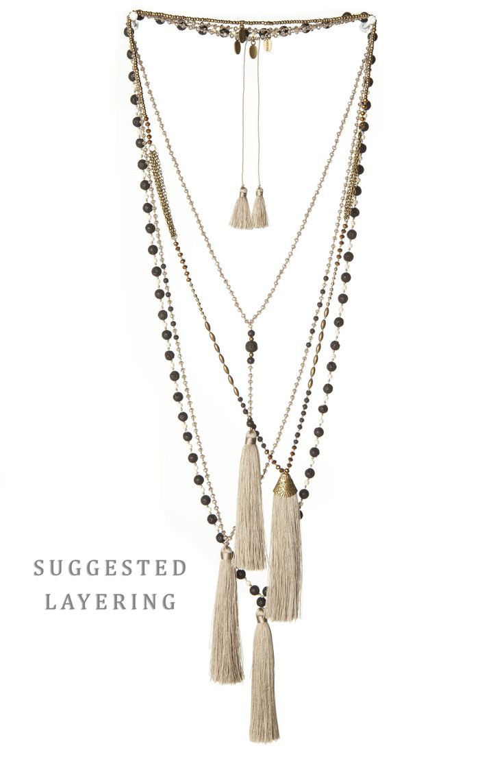 an image of a multilayered necklace with gold and silver chains, brown beads, and tassels hanging off. the necklace is styled in a bohemian chic style with elegant layering and statement pieces.