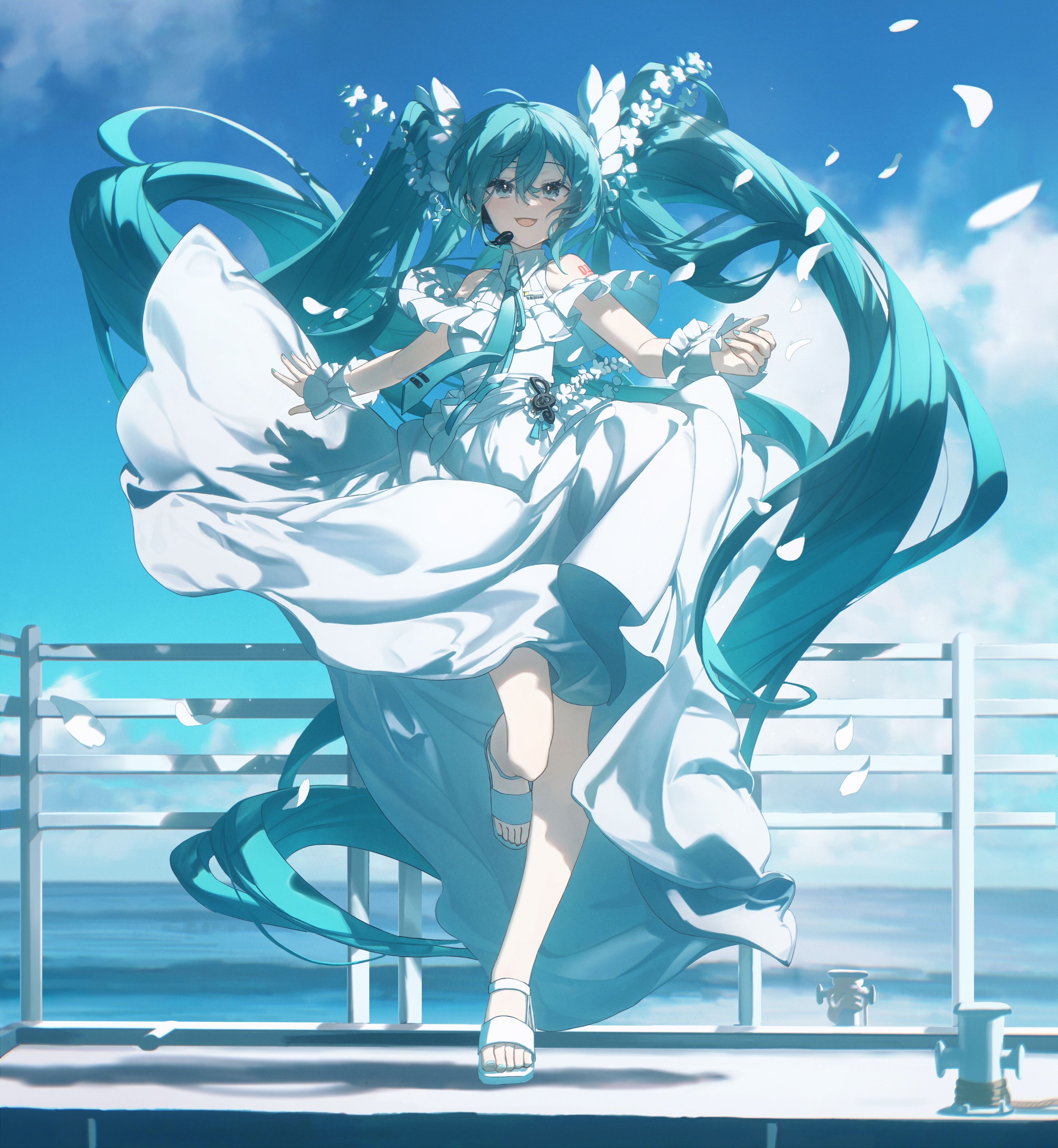 the image features hatsune miku, a vocaloid character, wearing a flowing white dress. she has long, turquoise hair and is standing on a platform with railings, overlooking the ocean under a partly cloudy sky. she is wearing sandals and her expression is joyful. flower petals appear to be floating around her.