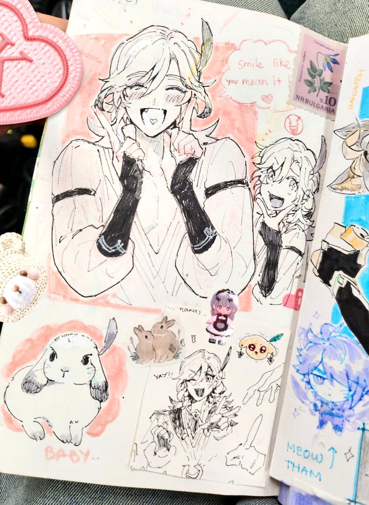 this is an image of a notebook page filled with anime drawings. the main drawing on the left side of the page is a young woman with long white hair and her hands covering her mouth as she smiles. she is drawn in a light and airy style with a pink background. on the right side of the page is a drawing of a young woman with long white hair and her hands by her face as she smiles. the other drawing on the page is a rabbit and is drawn in a cute cartoon style. there are also some stickers and drawings on the page that are related to anime characters. the notebook paper is white and there are hints of pink, purple, and blue on the page. the notebook is opened and lying flat on a table.