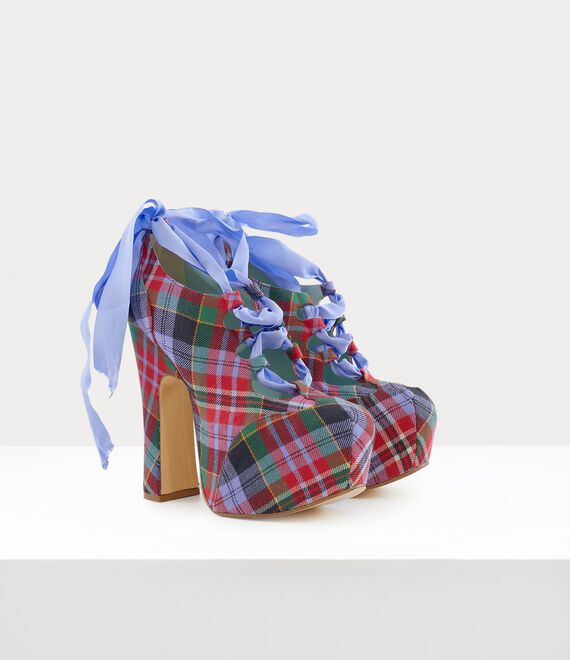 a pair of women's high heel platform shoes with blue tartan plaid and blue ribbons, the shoes are set against a white background.