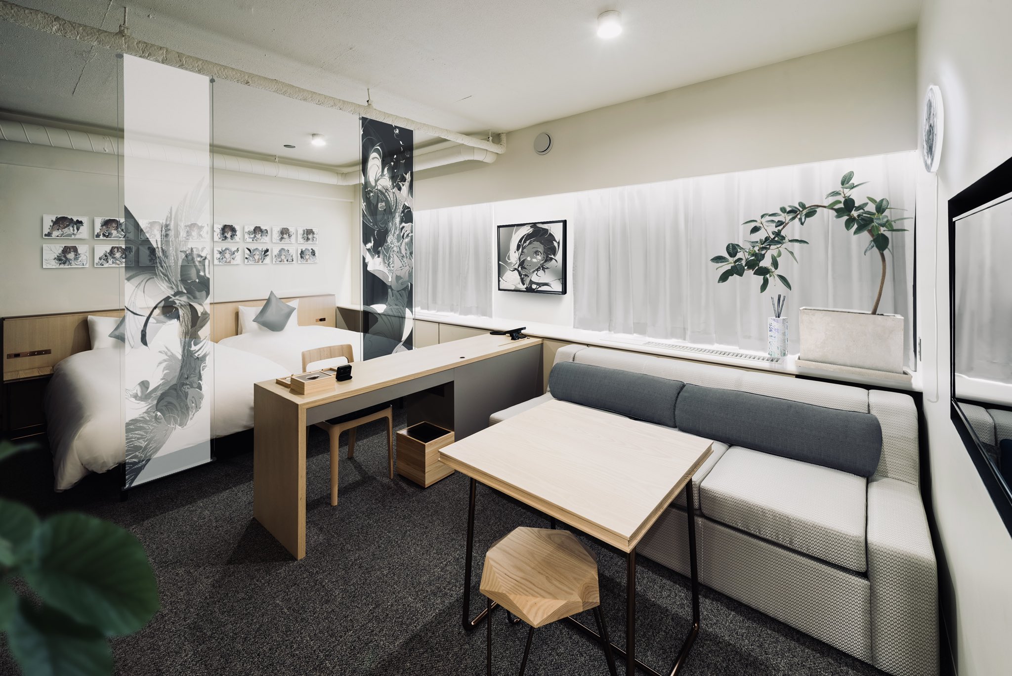 a modern hotel room with a minimalist design. the room features a bed, a couch, a table, and a chair. the walls are white and the floor is carpeted. there is a window with a white curtain. the room is decorated with black and white art. the lighting is artificial.